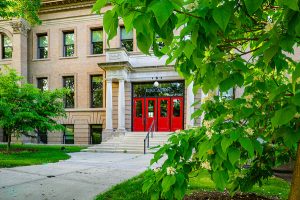 Education Hall famous red doors and tree foliage