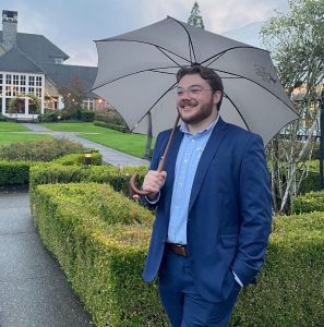Portrait of Phillip Pethan holding an umbrella
