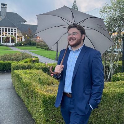 Portrait of Phillip Pethan holding an umbrella